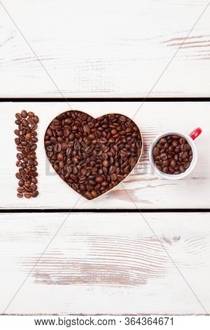 Roasted Beans Symbolizes Love For Coffee. Seeds Arranged In A Letter And Heart Shape.