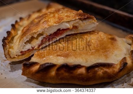 Cross Section Of Homemade Calzone On Parchment Paper