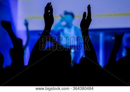 Man Silhouette Partying, Cheering, Raising Hands Up And Clapping At Rock Concert In Front Of Stage O
