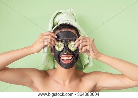Happy Smiling Girl Applying Facial Carbon Mask Portrait - Young Woman Having Skin Care Cleanser Spa 