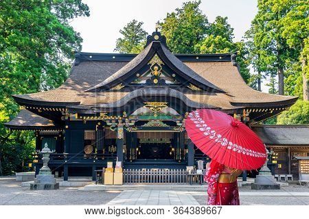 Woman Wearing Japanese Traditional Kimono With Umbrella At Katori Shrine In Chiba, Japan.