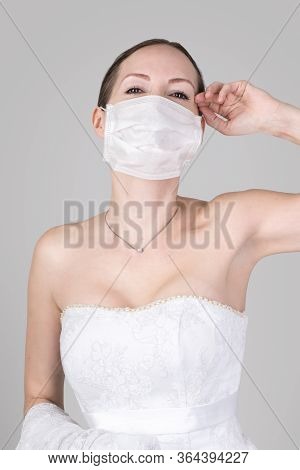 Beautiful Young Bride In A Wedding Dress And A White Medical Mask On Face