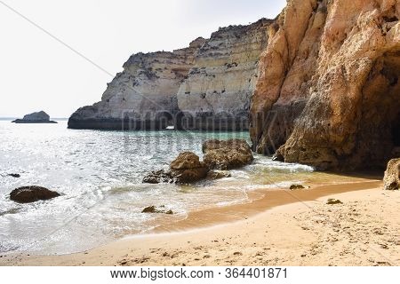 Empty Beach Between Cliffs. Uncrowded Travel Concept. Algarve, Portugal