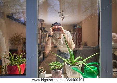 Man With Medical Mask On Their Faces Looking Through Window, Stay At Home, Selfisolation To Prevent 