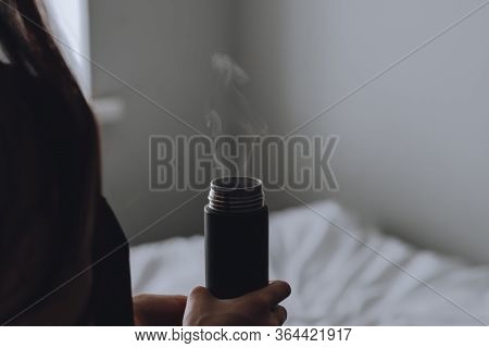 The Girl Holds In Her Hands A Cup With A Hot Drink From Which Steam Comes At Home.