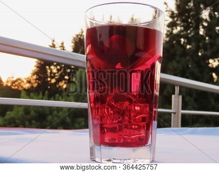Cold Sangria - Close Up Of Big Glass With Ice, Cherries, Apple Slices In Summer Heat. Blurry Backgro