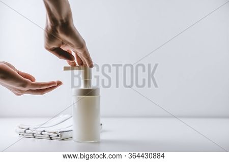 Woman Washes Hands, Squeezes Soap On The Palm On A White Background. Concept Of Protection Against G