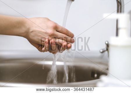 Woman Washes Hands, Squeezes Soap On The Palm On A White Background. Concept Of Protection Against G