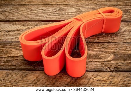 resistance exercise band for fitness and rehabilitation against wooden background