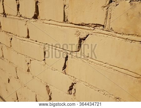 Background the old bricks of the building are painted yellow