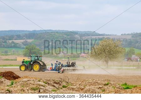 Lesna, Czech Republic - April 23 2019: Tractor With Seeder Planting Crops On The Field