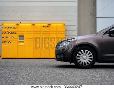 Paris, France - Mar 29, 2020: Side View Of New Skoda Octavia Car In Front Of Yellow Amazon Locker - 