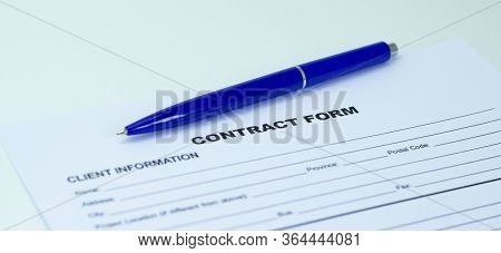 Blue Ballpoint Pen On Contract Papers. Lettering Contract On Paper.