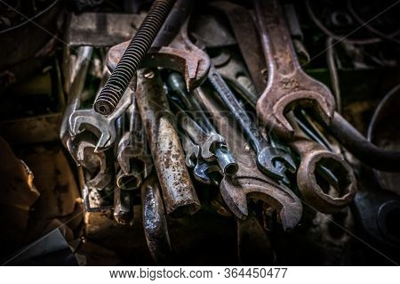 Hand Tools Set Of Old, Rusty Metal. On The Table Are Wrenches Of Various Shapes As Well As Files, Bo