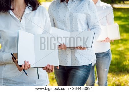 Young Beautiful Girls Drawing The Pictures In Sketchbook.