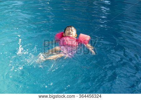 Asian Cute Girl Happinese In Swimming Pool.