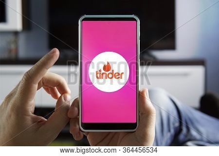 October 20, 2019. Barnaul. Russia. Men Holding Phone With Tinder Logo On The Screen. Tinder Is A Pop