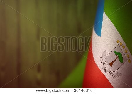 Equatorial Guinea Hanging Flag For Honour Of Veterans Day Or Memorial Day On Green Blurred Natural W