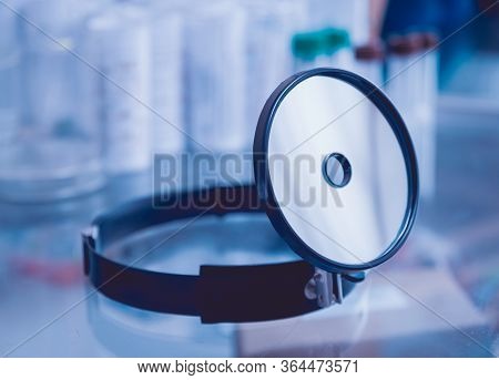 Medical Frontal Reflector On The Table. Background.