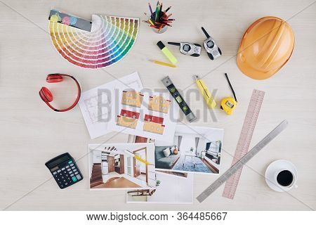 Table Of Professional Architect With Photos Of Interior Vizualization, House Blueprint, Hardhat And 