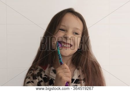 Little Girl Brushing Her Teeth. Girl With A Toothbrush. Oral Hygiene