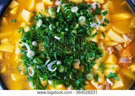 Background Stewed Potatoes With Meat Sprinkled With Fresh Herbs Close Up