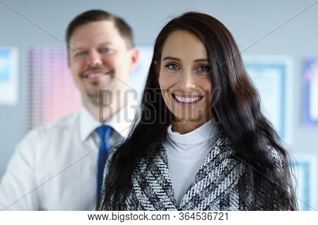 Portrait Of Business Partners Posing On Camera In Office. Businesspeople In Presentable Suits Smilin