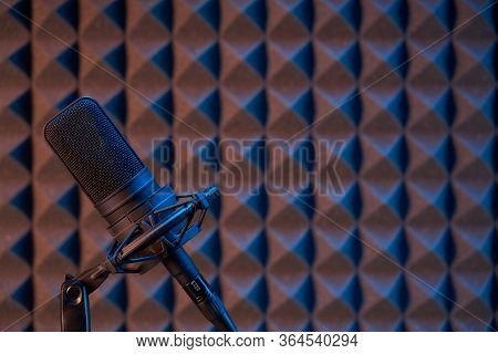 Studio Condenser Microphone On Acoustic Foam Panel Background