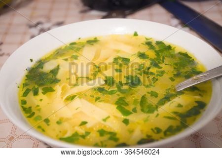 Traditional Romanian Supa Cu Galuste Or Soup With Dumplings. Chicken Stock Soup With Parsley On Top.