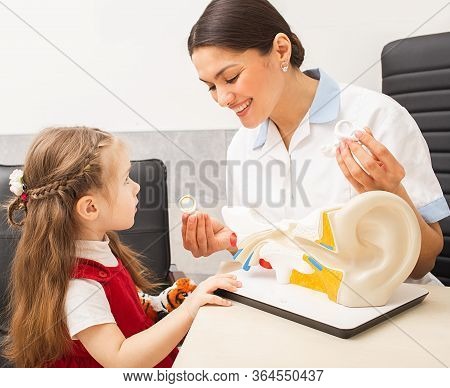 Ent Doctor Showing A Little Girl Patient A Structure Of Human Ear System On A Model Of Human Ear. Au