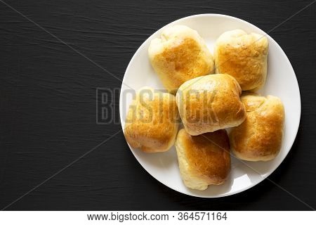 Home-baked Beef Russian Bierocks On A White Plate On A Black Background, Top View. Flat Lay, Overhea