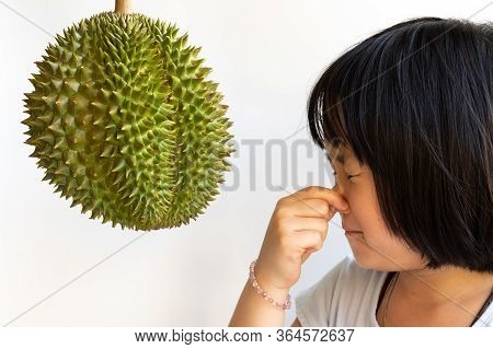 Cute Girl Squeeze Nose In Front Of Durian With White Background