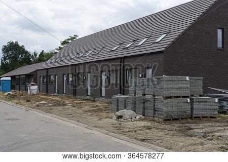 Sint Gillis Waas, Belgium, 16 August 2019. New Construction Of Houses With Stones In The Foreground 