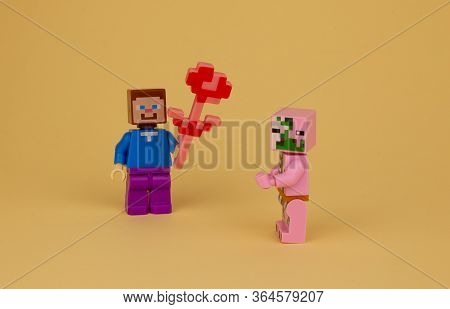 Ukraine, Kyiv - April 3, 2020: A Man Gives Flowers To A Woman. Congratulation. Lego Figures. Minecra