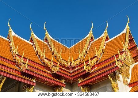 Details Of Typical Thai Traditional Roof With Ceramic Tiles And Golden Ornamentation