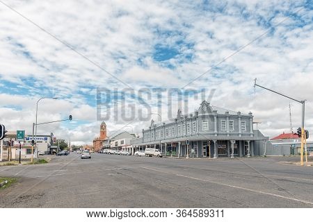Harrismith, South Africa - March 16, 2020:  A Street Scene, With Businesses And Vehicles, In Harrism