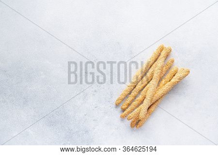 Organic Italian Grissini Or Salted Bread Sticks And Bread Lying On A Gray Background. Fresh Italian 