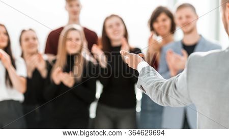 Blurry Image Of A Group Of Different People Standing In A Confe
