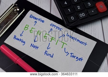 Benefit Write On A Book With Keywords Isolated On Wooden Background. Finance Concept