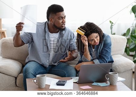 Wife Spender. Angry Black Man Shouting At His Spouse At Home For Huge Credit Card Bills, Failed Abou