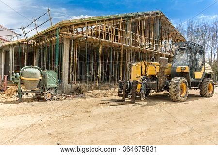 Construction Of A Single-family House With Professional Tools: Concrete Mixer, Scaffolding And A For
