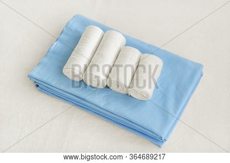 Medical Elastic Bandage On Blue Bed Sheet On A White Background