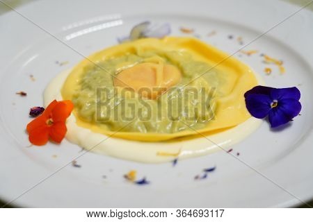 Delicious Raviolo Pasta On A Creamy Sauce. Italian Cuisine