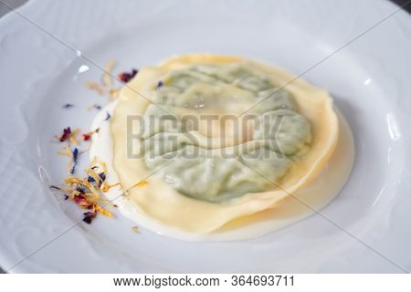 Delicious Raviolo Pasta On A Creamy Sauce. Italian Cuisine