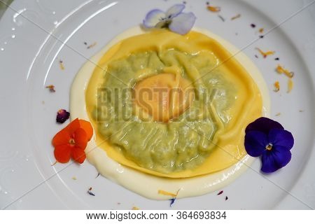 Delicious Raviolo Pasta On A Creamy Sauce. Italian Cuisine