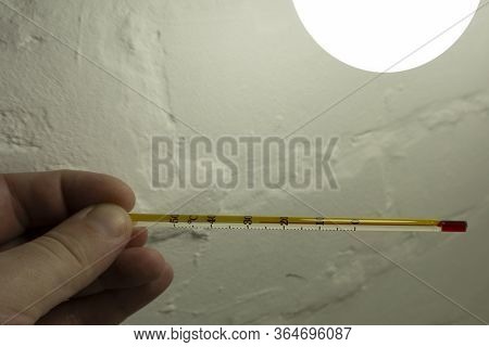 Alcohol Meter In Hand By The Lamp .