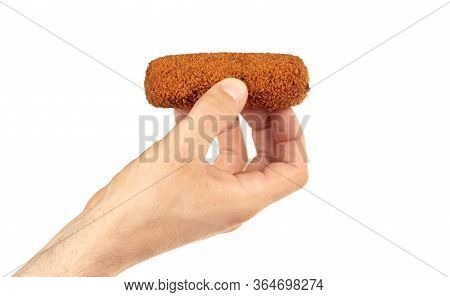 Brown Crusty Dutch Kroket Held By An Adult Man, Isolated On A White Background