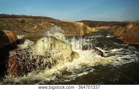 Discharge Of Waste Water Into The River. Violation Of Environmental Ecology.