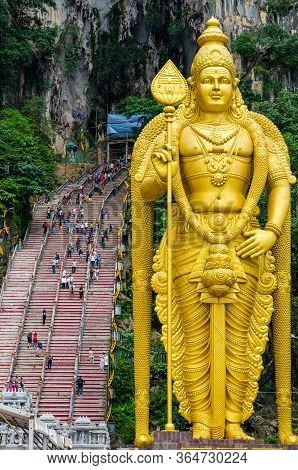 The Golden Statue Of Lord Muragan Outside The Batu Caves Hindu Shrine In Kuala Lumpur In Malaysia.