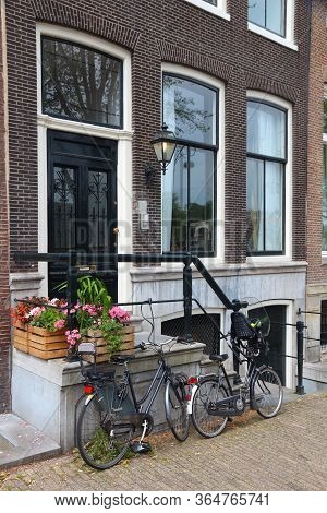 Amsterdam Residential Street - Generic Old House Ornate Door. Netherlands Rowhouse. Parked Bicycles.
